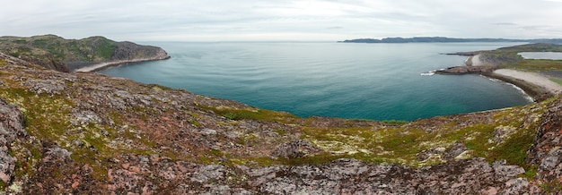 View on the rocky shore of the Barents sea. Kola Peninsula, The Arctic, Russia.