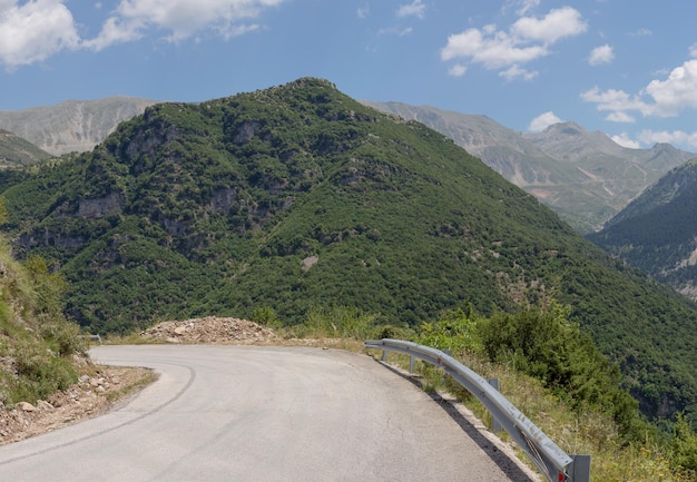 晴れた夏の日の地域の田舎道と山々の眺めTzoumerkaEpirusギリシャ