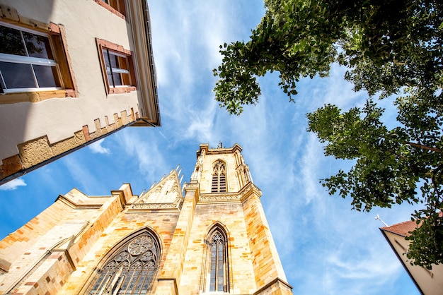 View on the saint Martins cathedral in the center of Colmar town during the sunny weather in Alsace region, France