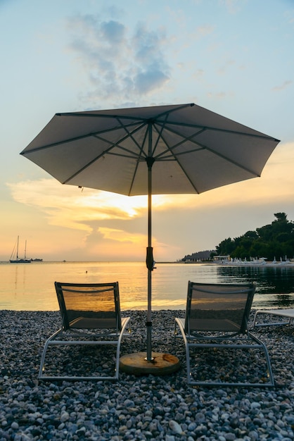 View of sea beach with sun loungers and umbrellas