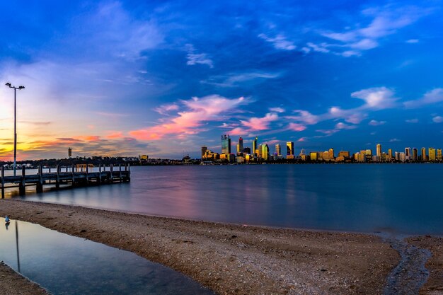 夕暮れの空に照らされた海と建物の景色