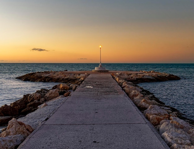 View of the sea and Lamppost on the Pedregalejo Beach at dusk