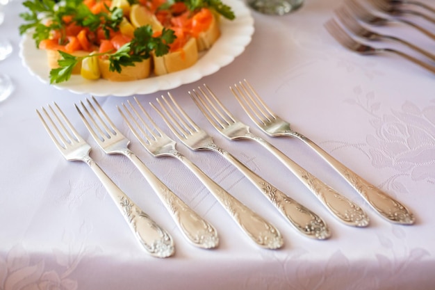 View of the served for decorated wedding dinner table with glasses in the restaurant