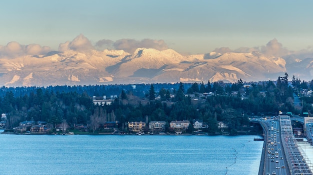 A view of the shoreline of bellevue washington with mountains in the distance