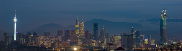 Photo view of skyscrapers lit up at night