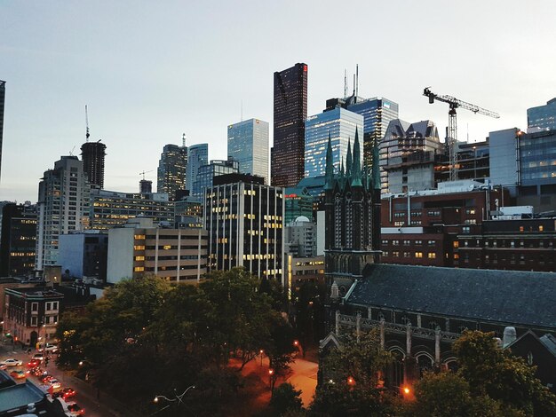 Photo view of skyscrapers lit up at night