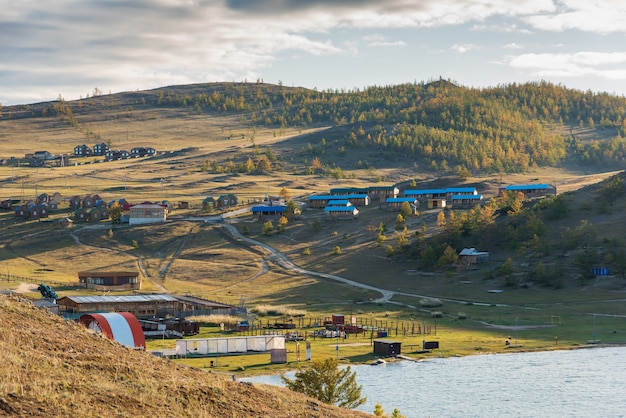 View of small sea strait on lake baikal on autumn day joy bay with houses