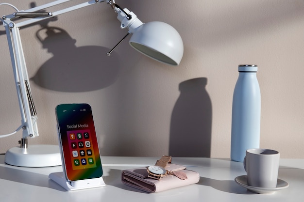 View of smartphone on desk with assortment of items