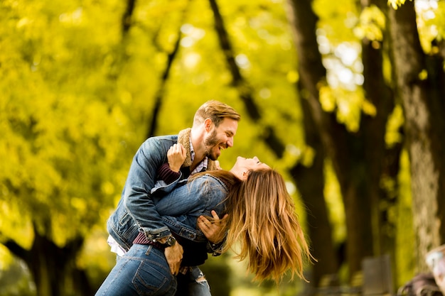 View at smiling couple hugging in autumn park