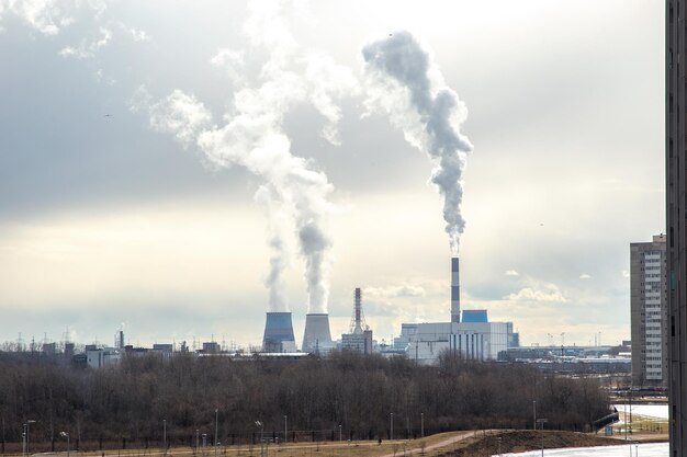 view of the smoking chimneys of a power plant against the backdrop of a beautiful sky.