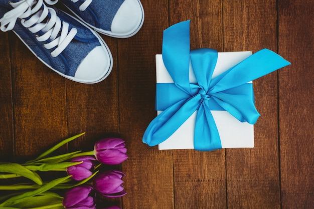 View of sneakers and blue gift