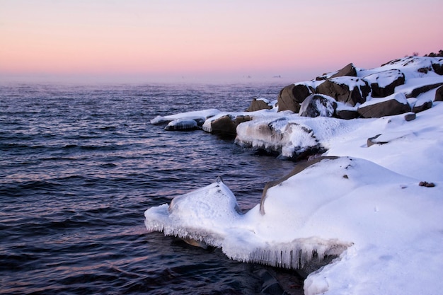 view of snow covered coastline at dawn