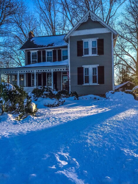 View of snow covered house and yard