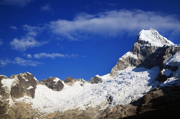 View of snowcapped mountain peak against cloudy sky