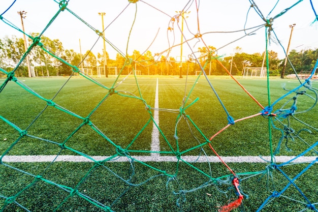 Photo view of soccer goal against sky during sunset