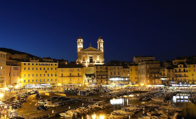 View of St Jean Baptiste cathedral and old port of Bastia second largest corsican city .