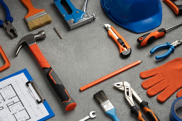 Photo view of steel hammer with other construction elements and tools