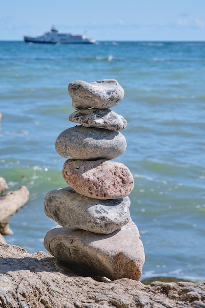 View of stone tower on the beach and sea as background