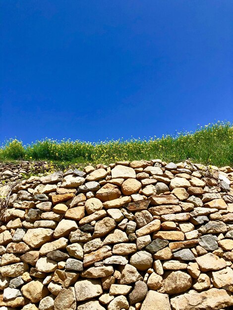 View of stone wall against blue sky