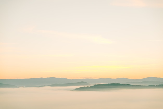 View of sunrise above mountains mist in the bottom landscape