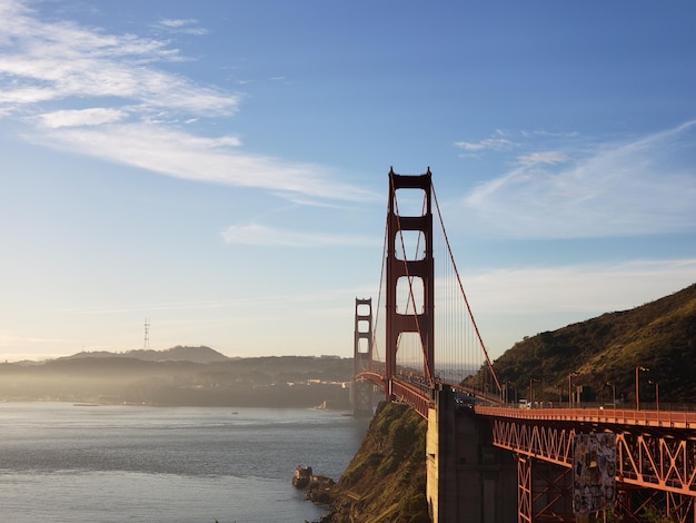 View of suspension bridge against cloudy sky