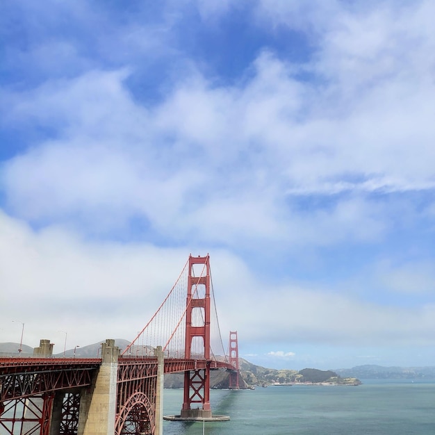 View of suspension bridge against cloudy sky