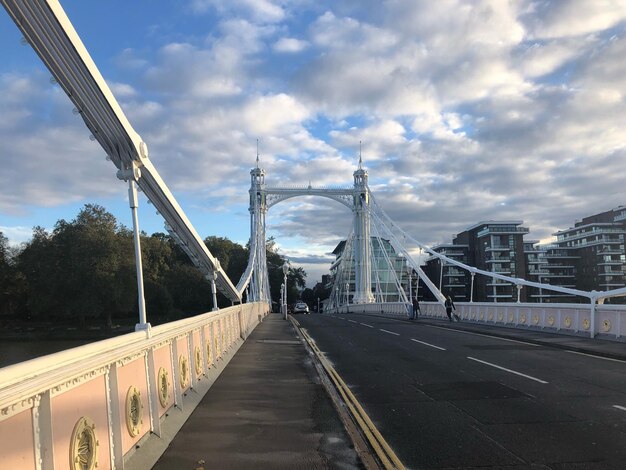 View of suspension bridge against cloudy sky