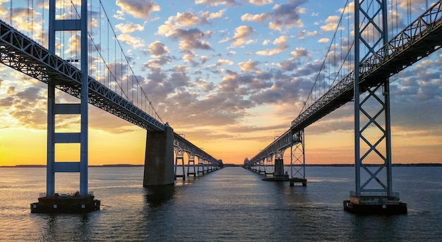 View of suspension bridge in city at sunset