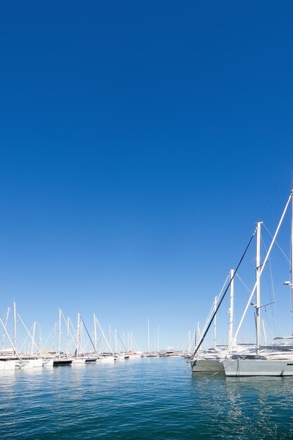 View of suspension bridge over sea against blue sky