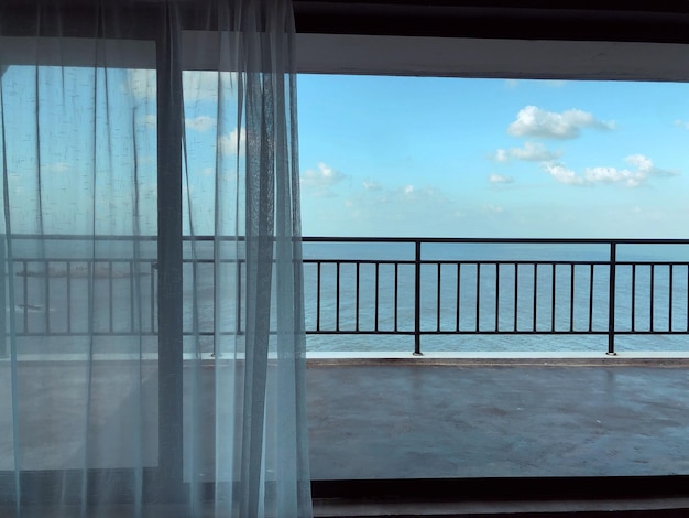 view of swimming pool against sky seen through window