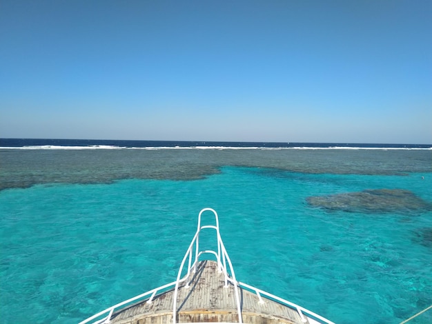 View of swimming pool by sea against clear sky