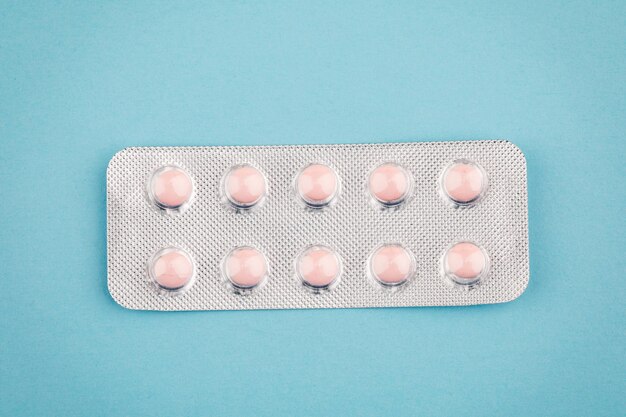 View of tablets in a blister on a blue background