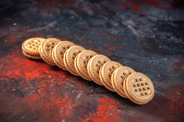 Photo above view of tasty sugar cookies laid side by side on mix colors background with free space