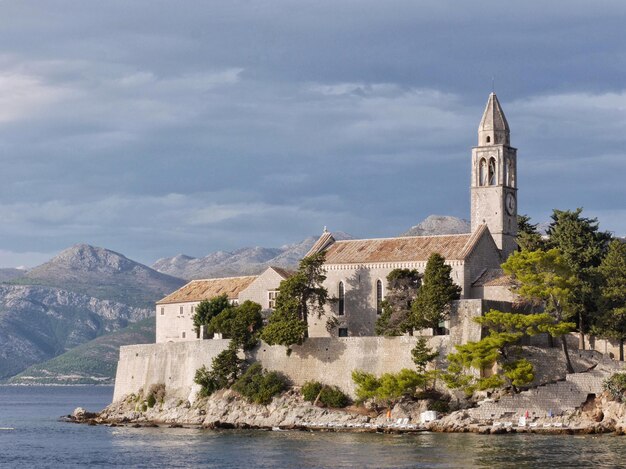 View of temple by sea against sky