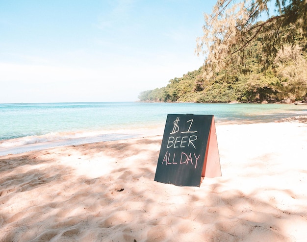 Photo view of text on beach against sky