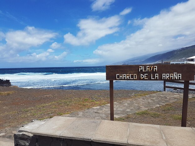 View of text on beach against sky