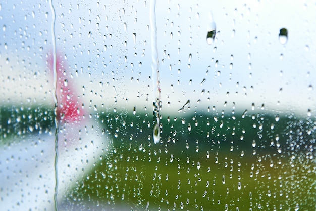 View through the foggy glass of an airplane before takeoff on a rainy day