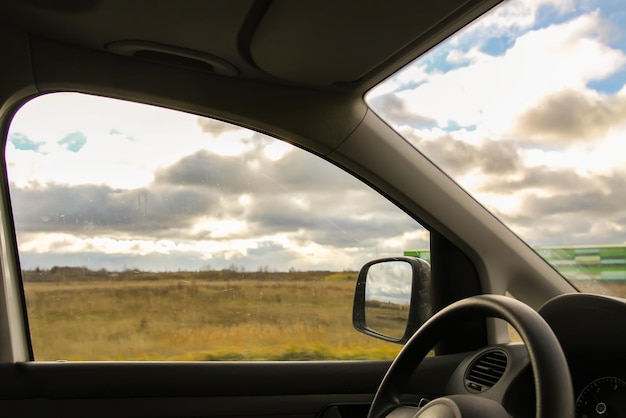 View through the moving car windscreen inside the car interior