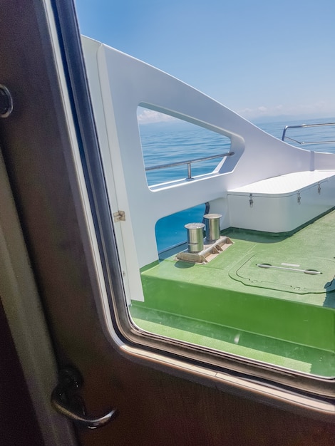 View through the porthole on the deck of a luxury yacht, close-up.