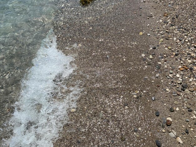 View through wet pebble on the sea