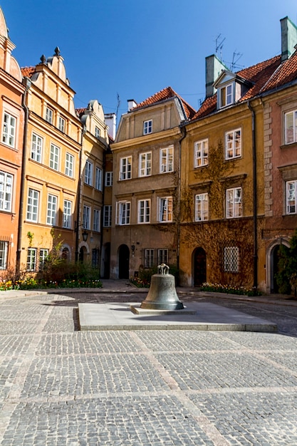 View towards the old town of Warsaw in Poland showing the old cracked bell from the cathedral now in a town square