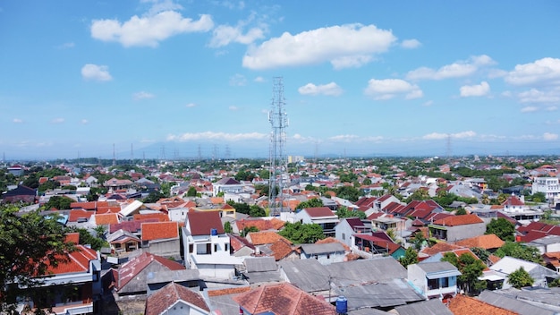 A view of a town with a blue sky and clouds