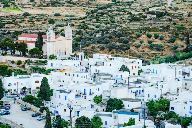 View on traditional whitewashed houses holy trinity monastery and countryside road in lefkes