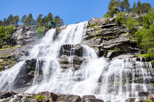 View of Tvindefossen or Tvinnefossen waterfall near Voss in Norway