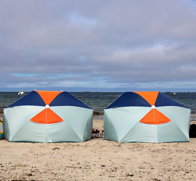 View of two parasols protecting a family from the sun