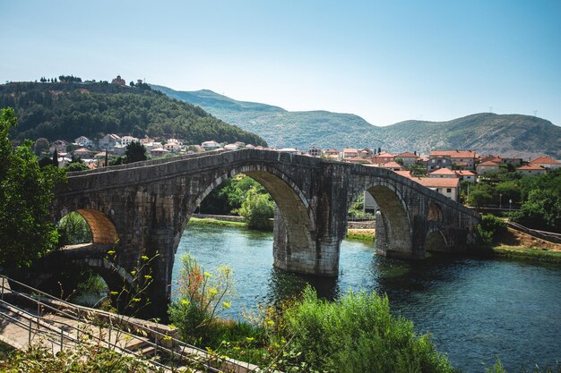 View of a twoarched bridge over the river in the beautiful town