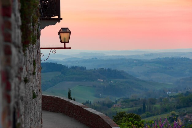 View at the valley from the San Gimignano walls at sunset time