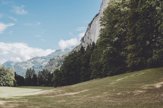 View valley of waterfalls in city Lauterbrunnen, Switzerland, Europe. Summer landscape, sunshine weather, dramatic blue sky and sunny day