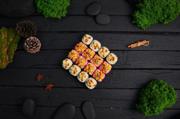 Above view of various sushi and rolls placed on stone board japanese food fest top view flat lay