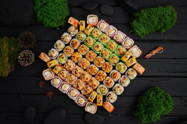 Above view of various sushi and rolls placed on stone board japanese food fest top view flat lay